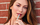 Model wearing summer makeup and drinking smoothie