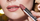 model applying lip color