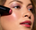 Model applying cheek crayon