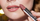 model applying lip color