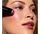Model applying cheek crayon