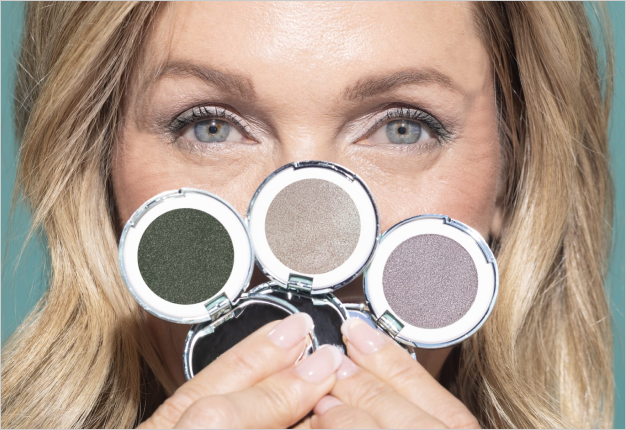 Woman holding eyeshadows