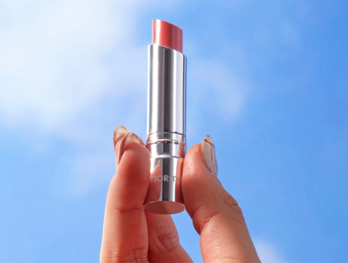 Hand holding lipstick Hand holding lipstick