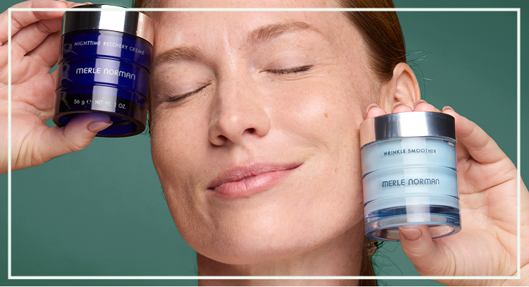 Two skincare cream jars held near the face with labels visible